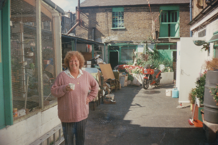 Betty Fleming in front of the aviary in the transformed Stonhouse Street yard.