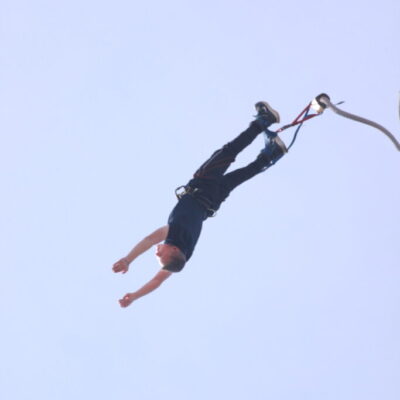 Freddie completes a bungee jump. Image is in mid-air