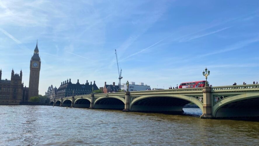 Westminster Bridge. The Houses of Parliament are visible to the left hand side of the image; a red London bus is crossing the bridge